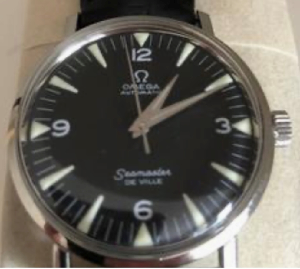 Mid-1960s Omega Seamaster De Ville, black dial with applied triangular markers and a railroad-track minute ring, on a black leather strap.